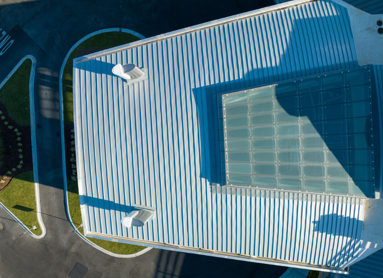 An aerial view of a building with a blue roof