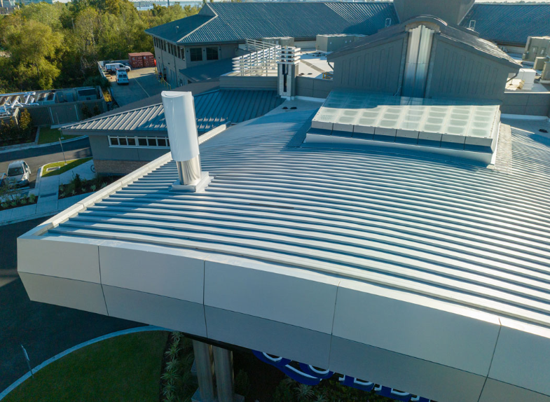 An aerial view of a large building with a curved roof.