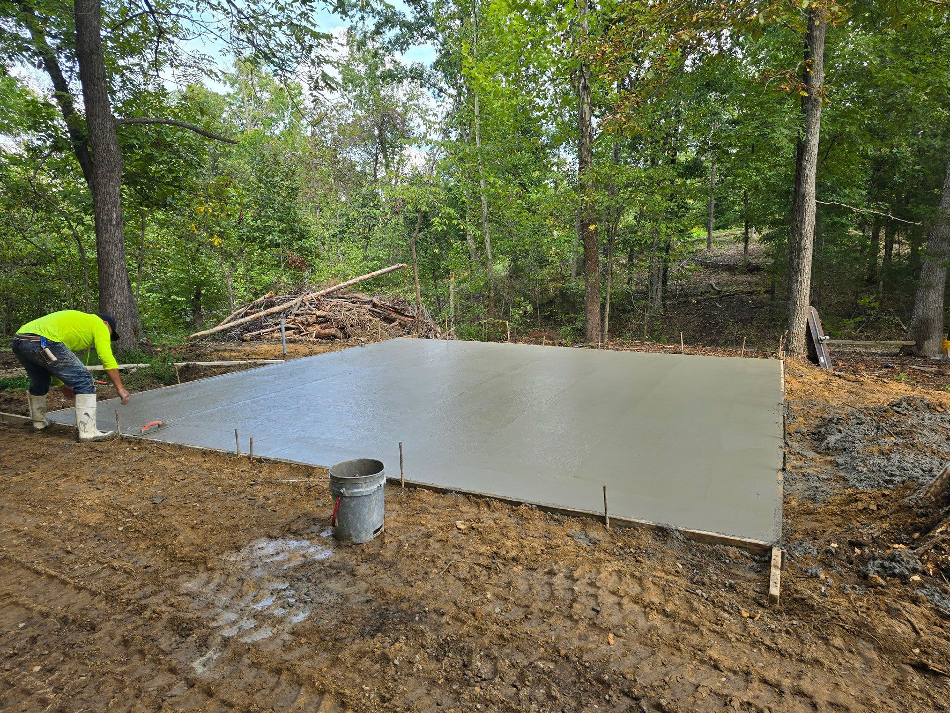 A man is working on a concrete slab