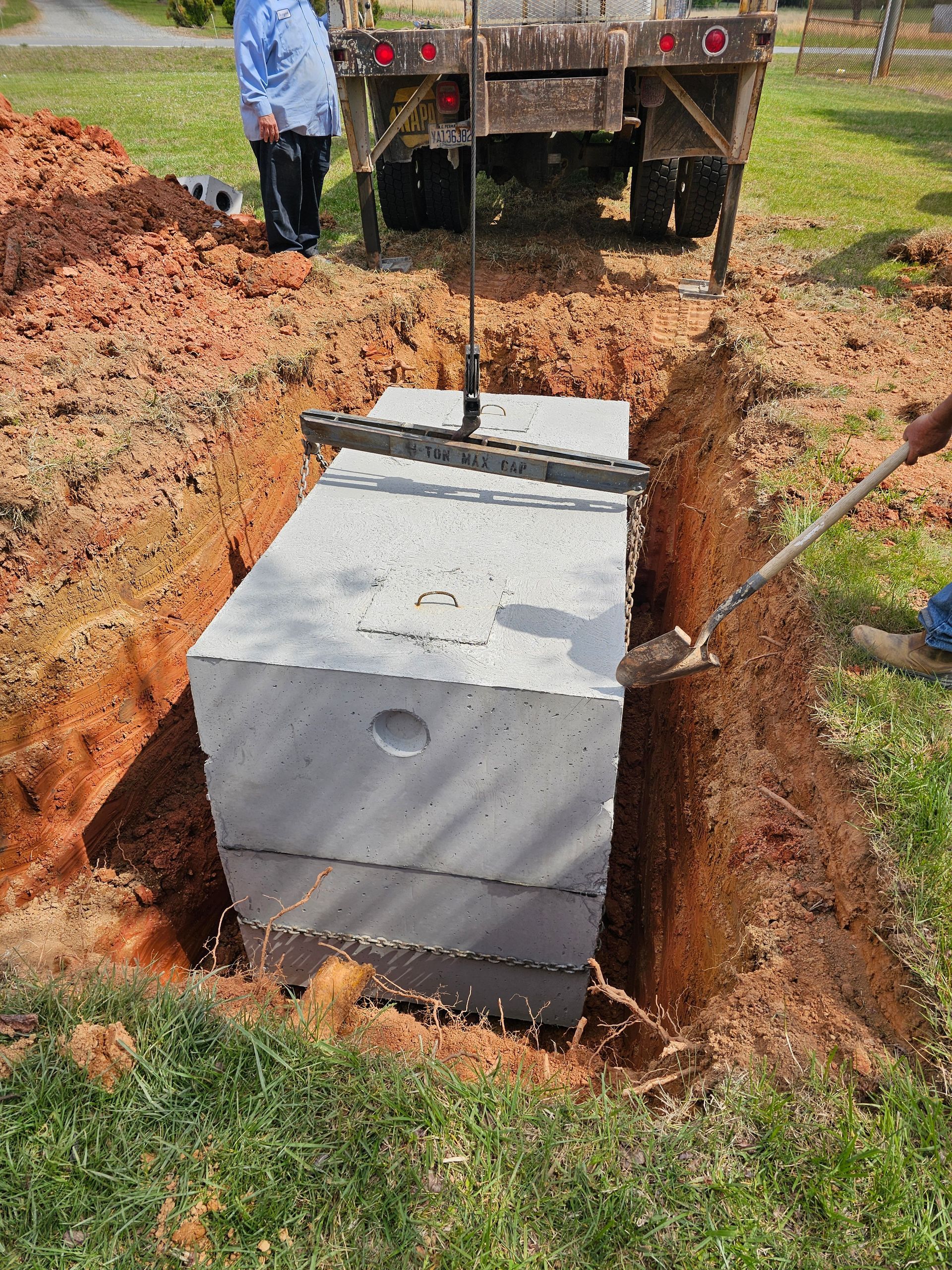 A man is digging a hole for a septic tank.