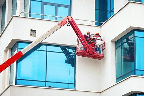 A group of people are cleaning the windows of a building.