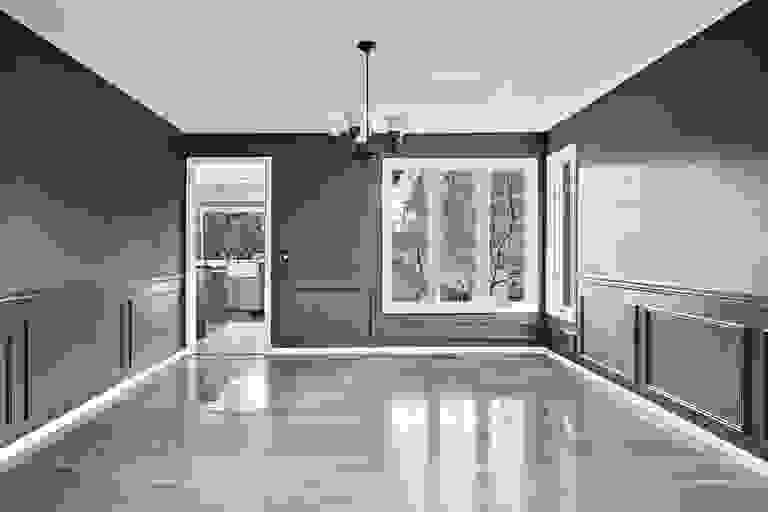 A black and white photo of an empty room with a ceiling fan.