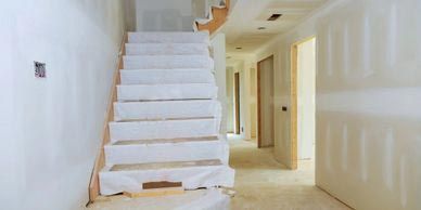 A staircase is being built in a hallway in a house.
