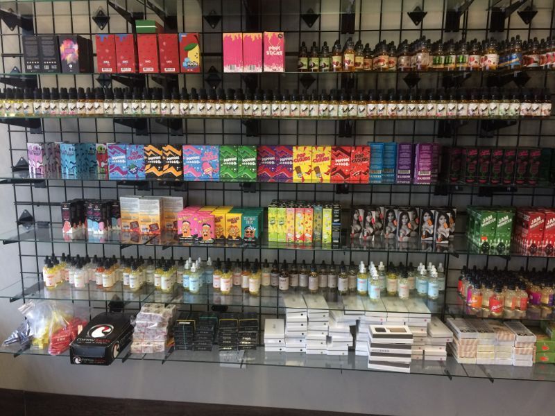 Shelves of colorful vape products displayed in a shop.