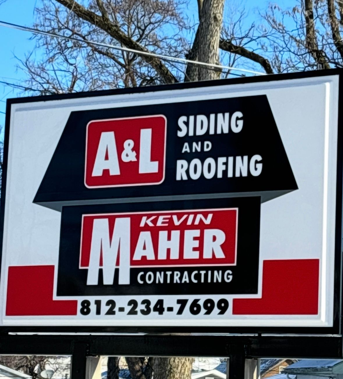A white sign for A&L Siding and Roofing and Kevin Maher Contracting with their phone number 812-234-7699.