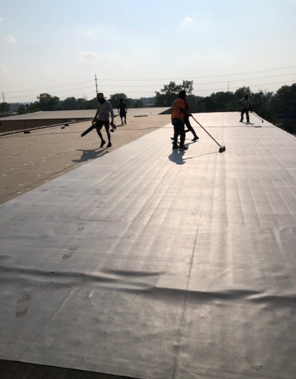 A group of people are working on a roof