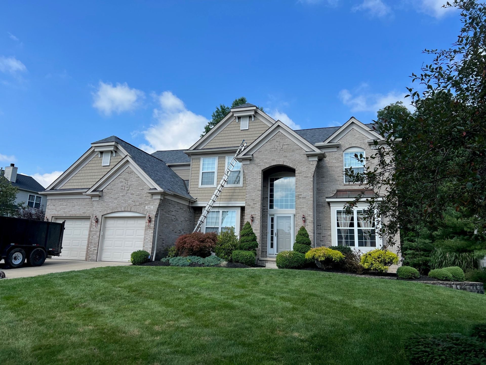 Front house with front yard garden and trees