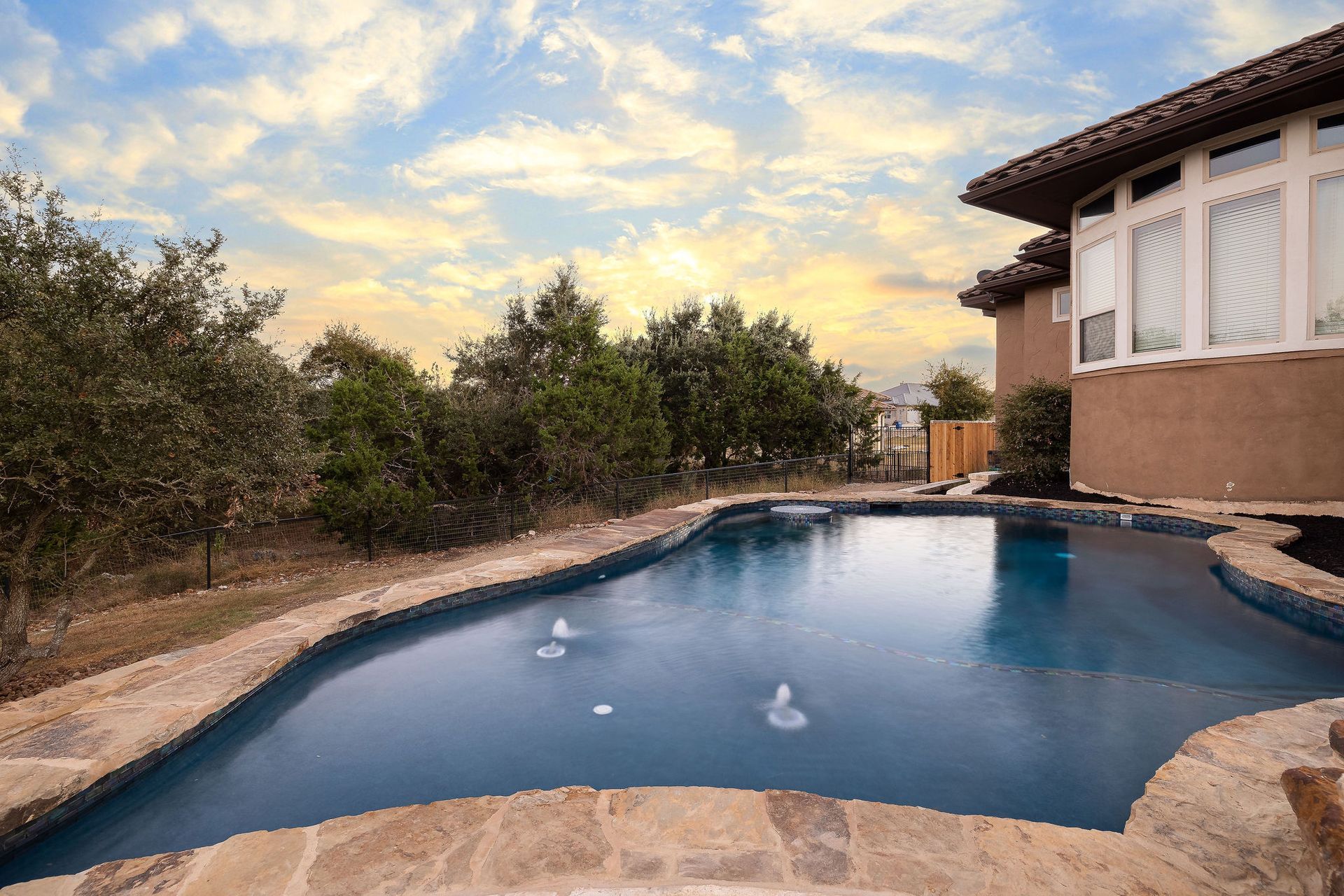 backyard pool at sunset