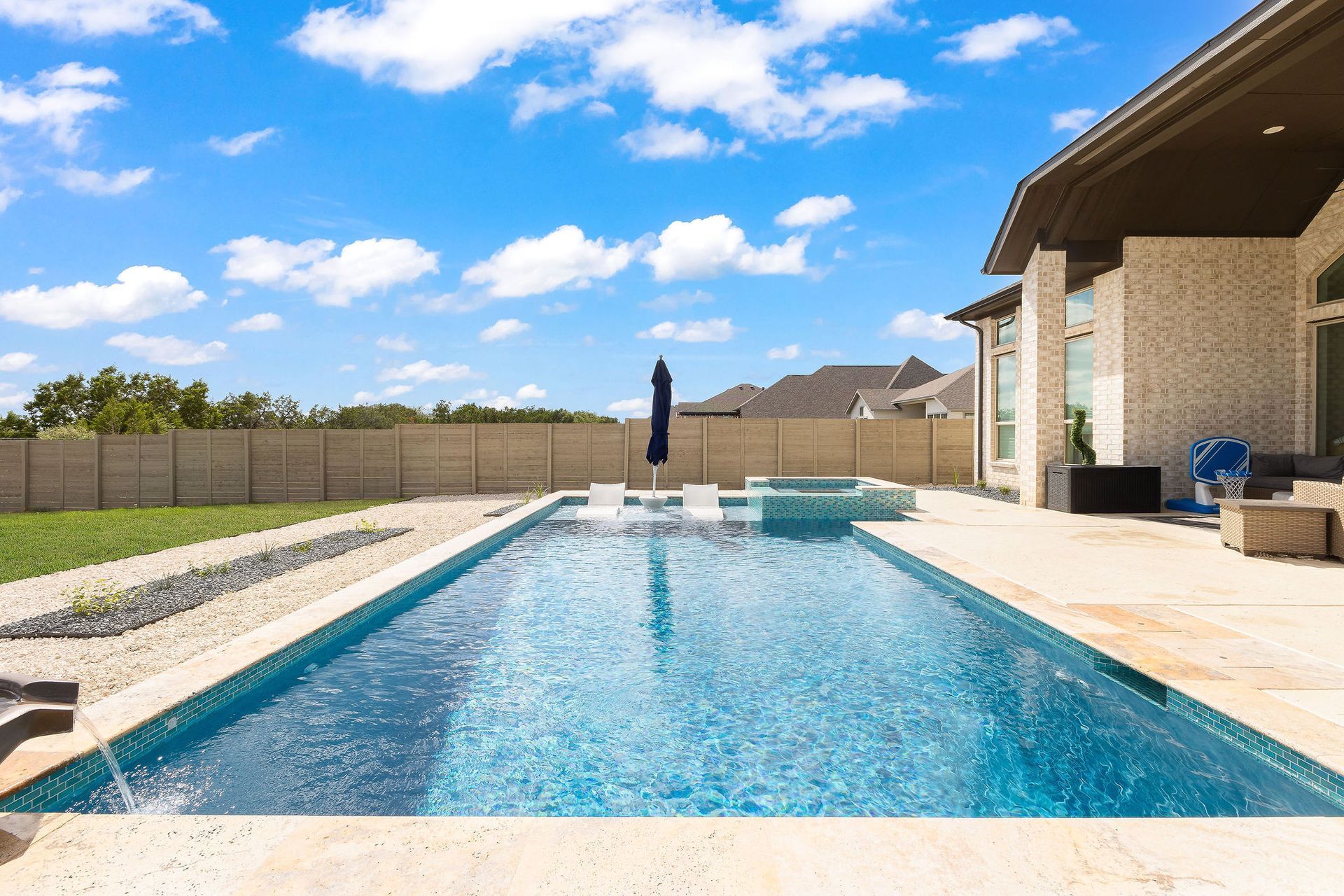 Backyard patio with a rectangular swimming pool