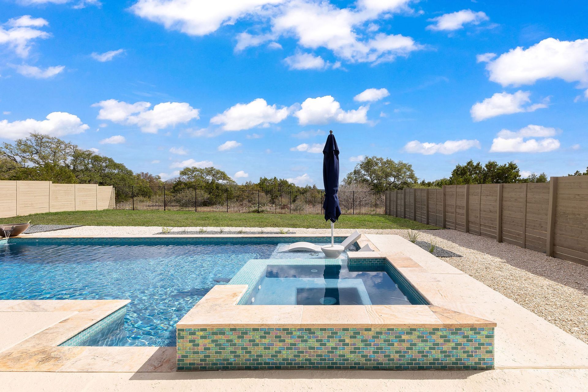 Backyard patio with a rectangular swimming pool