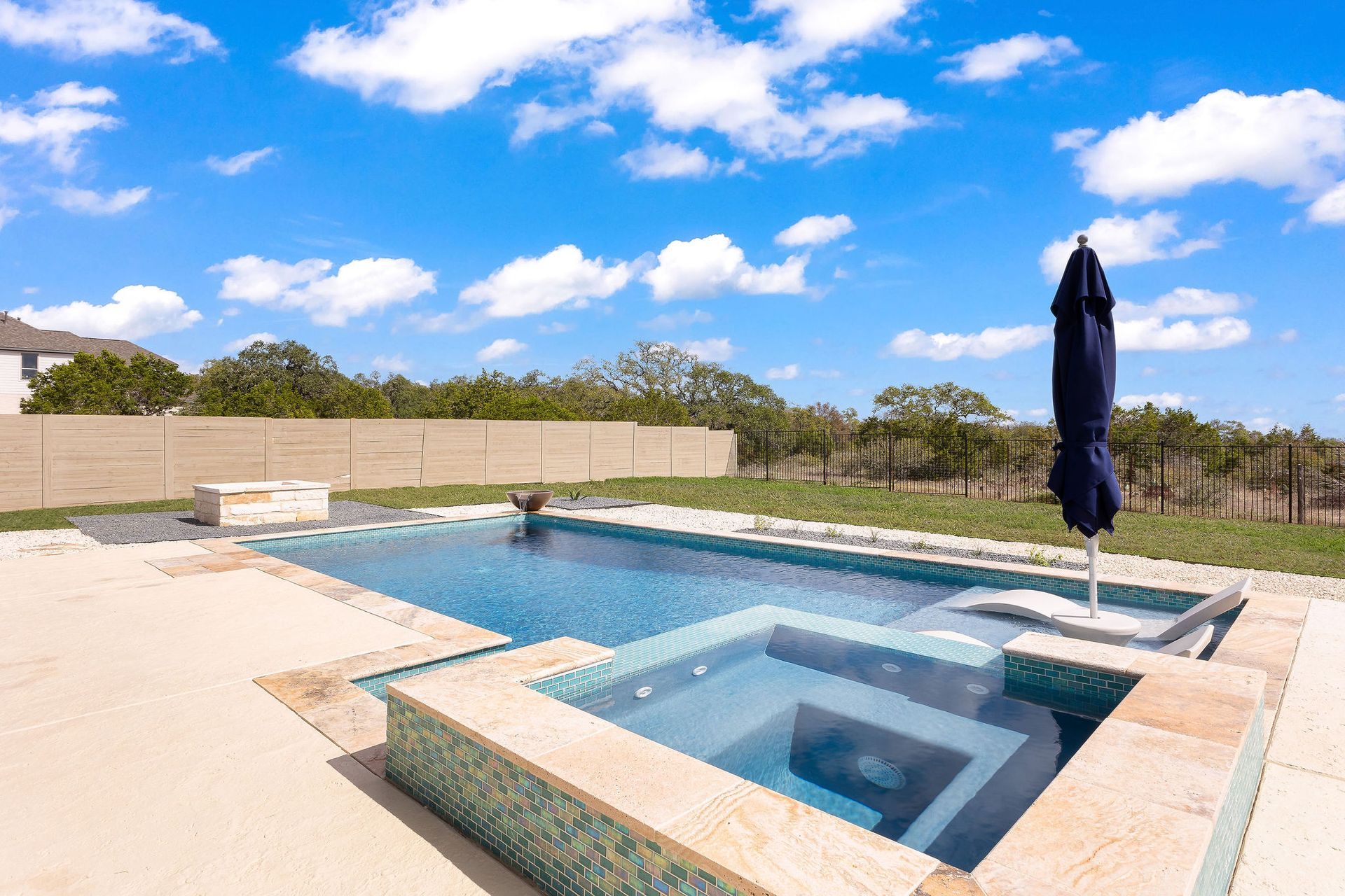 Backyard patio with a rectangular swimming pool