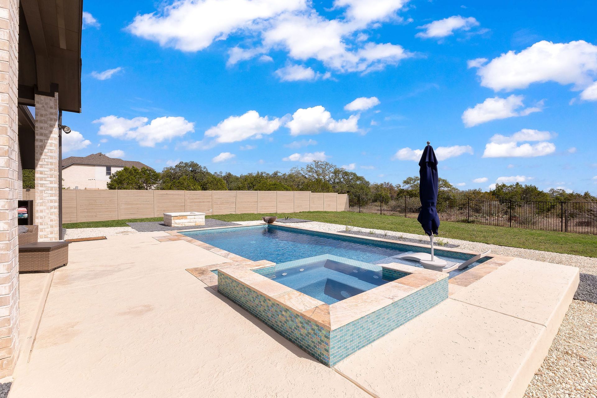 Backyard patio with a rectangular swimming pool