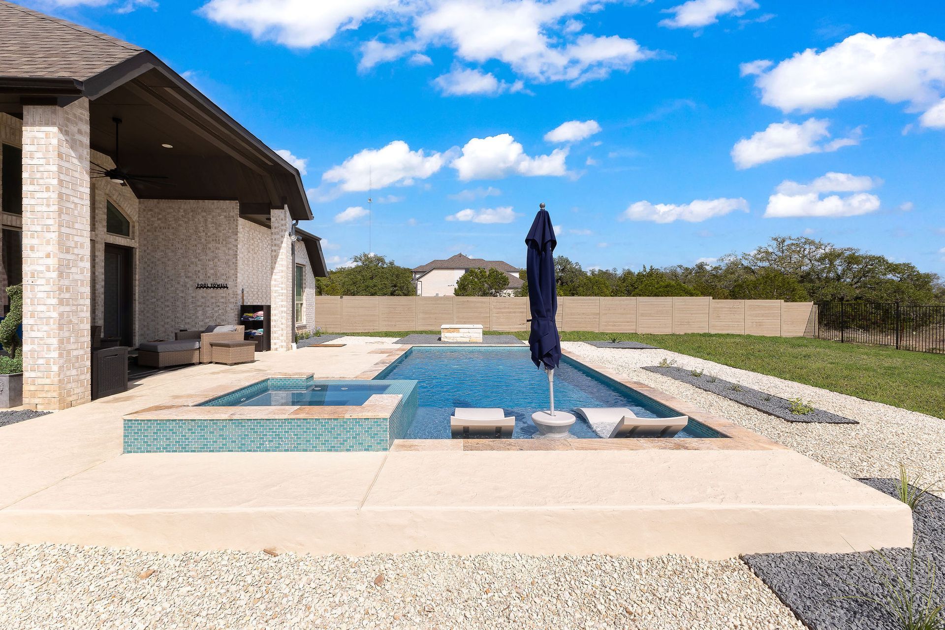 Backyard patio with a rectangular swimming pool