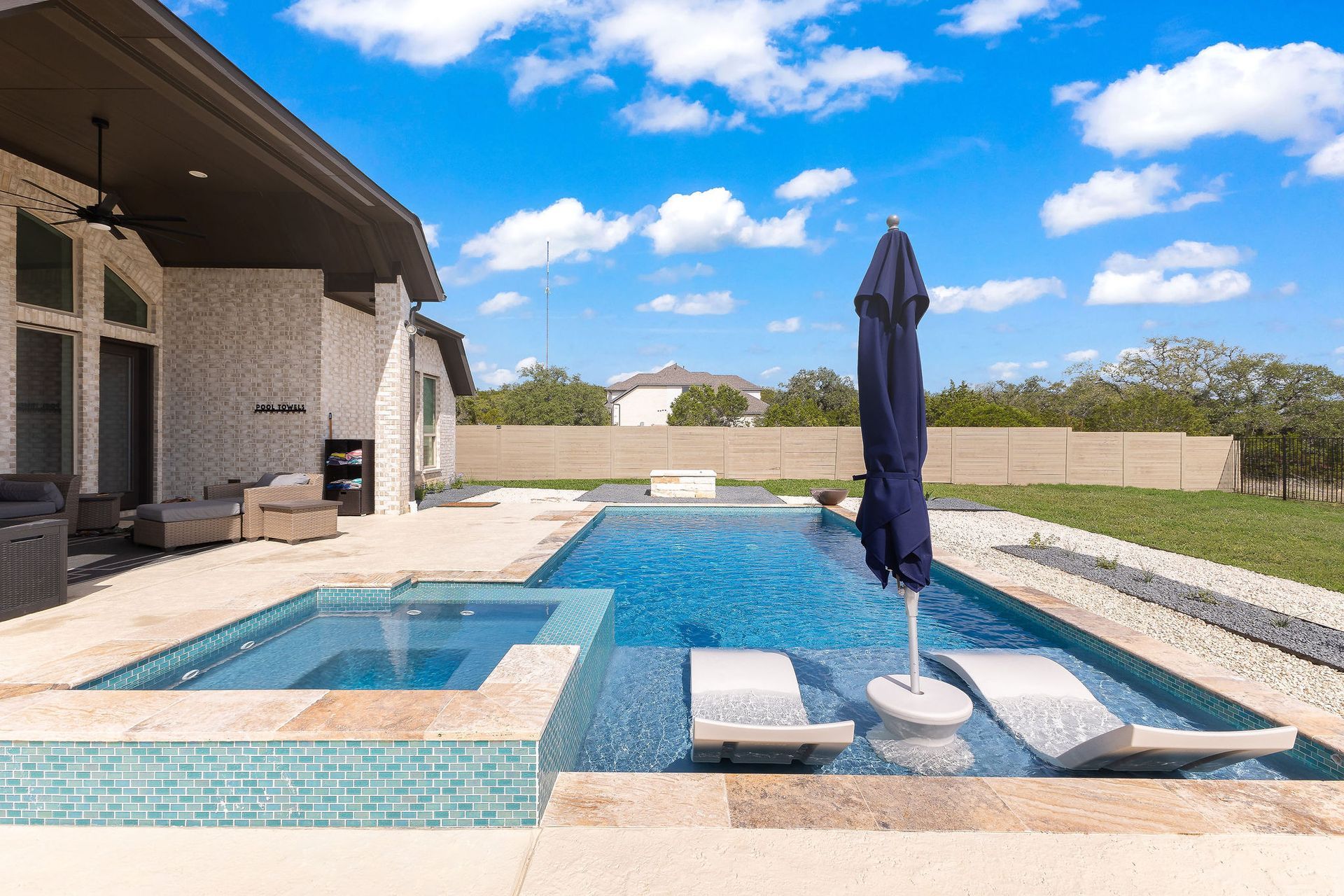 Backyard patio with a rectangular swimming pool