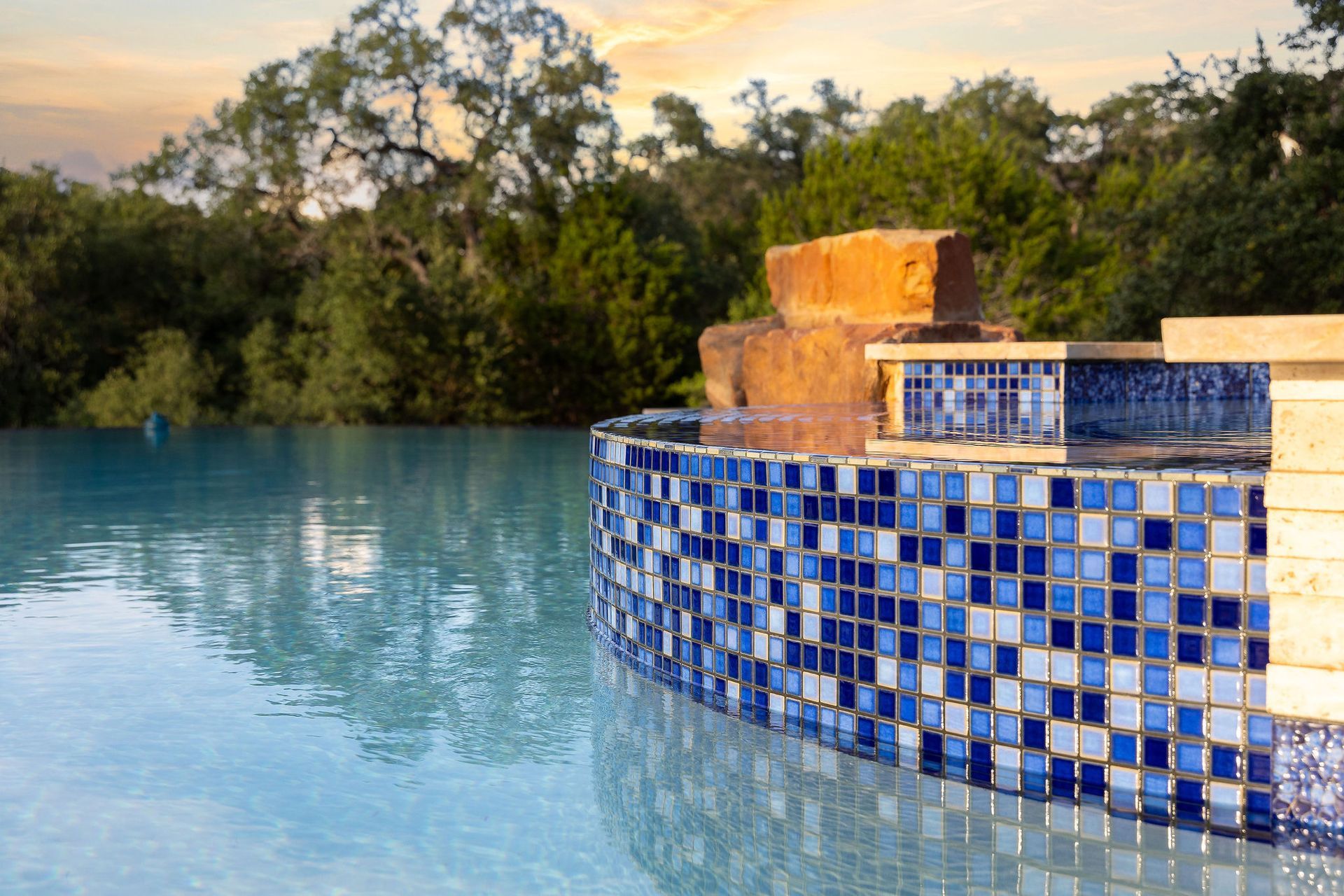 Backyard pool with a raised spa