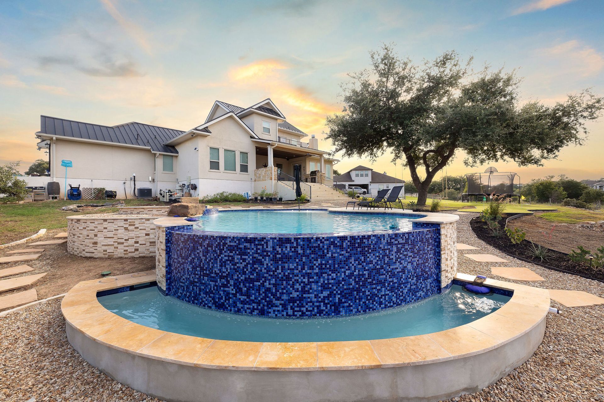 Backyard pool with a raised spa