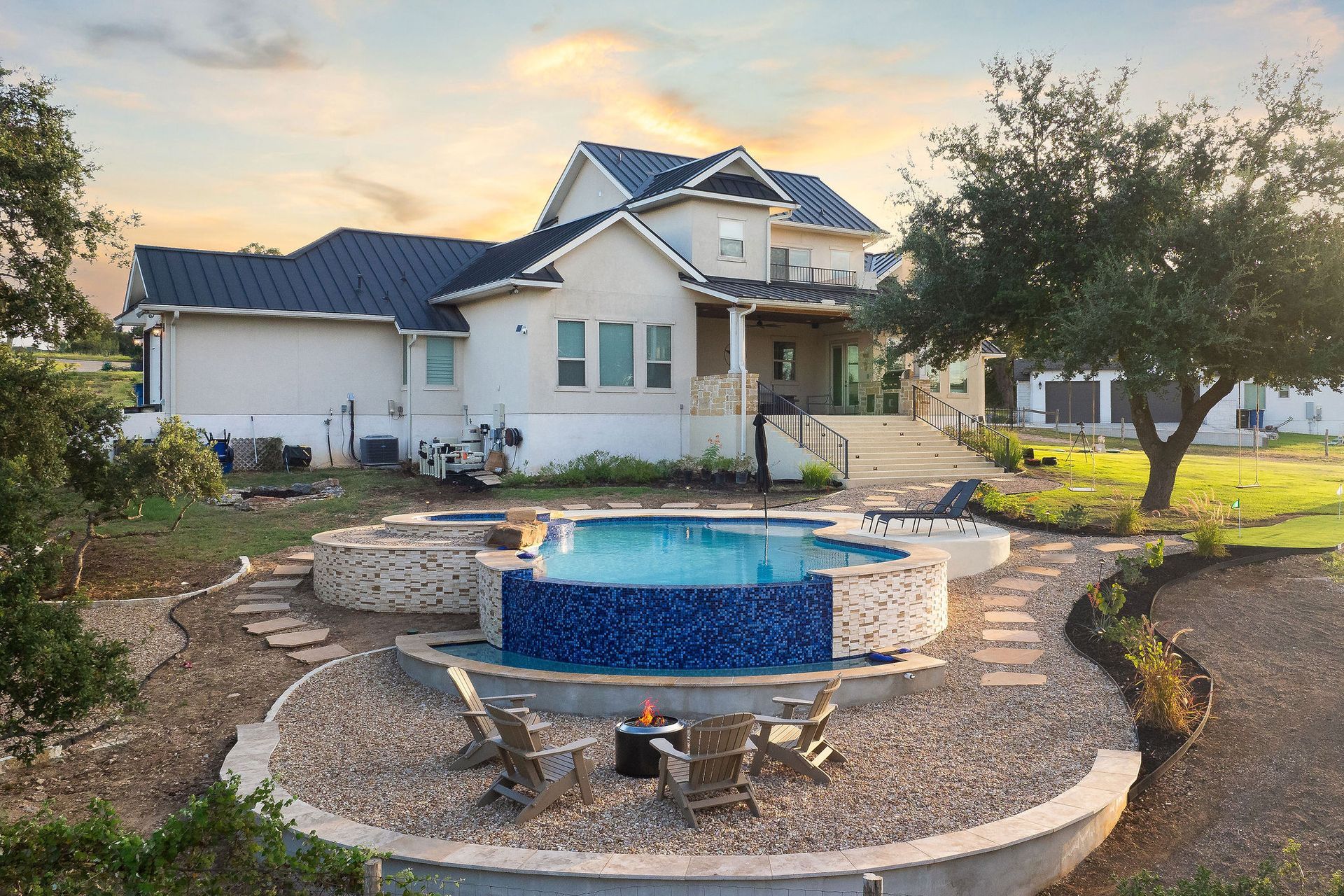 Backyard pool with a raised spa