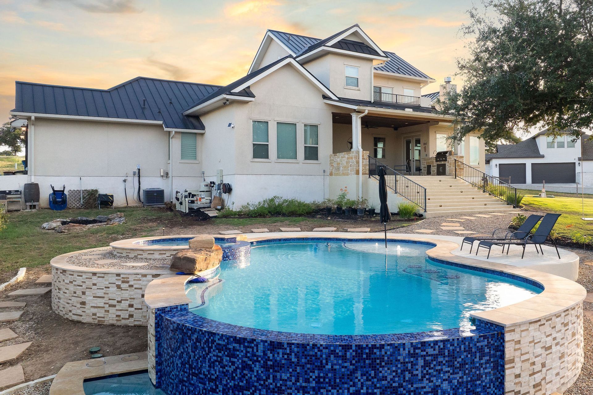 Backyard pool with a raised spa
