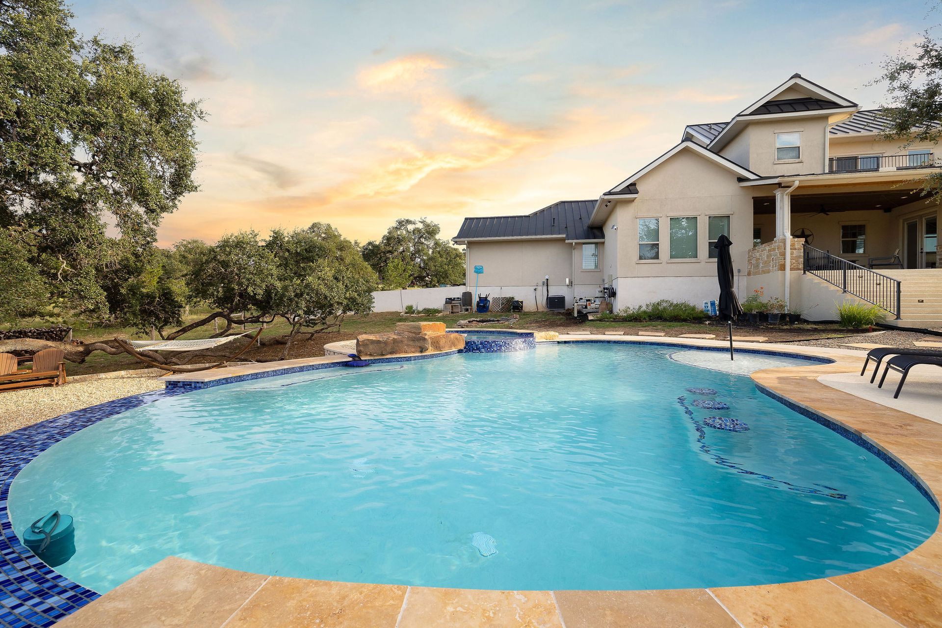 Backyard pool with a raised spa