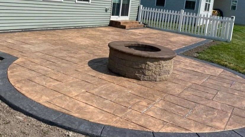 There is a fire pit in the middle of the patio.