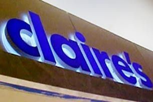 Blue store sign on a tan building facade