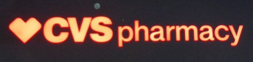 CVS Pharmacy logo in orange with a heart icon on a dark background