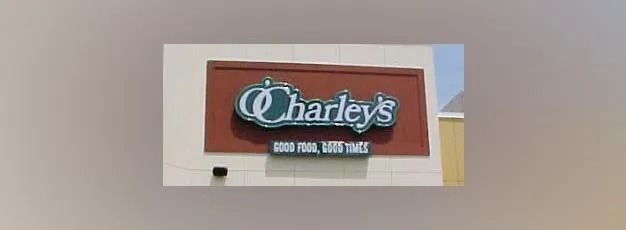 Charley's storefront sign on a red-brown panel above a beige building