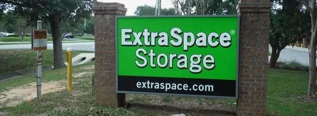 ExtraSpace Storage roadside sign with green and black logo and website text