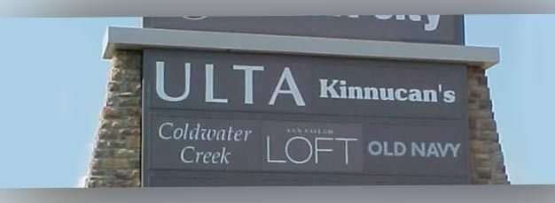 Store sign listing ULTA, Kinnucan’s, Coldwater Creek, Loft, and Old Navy on a blue sky background