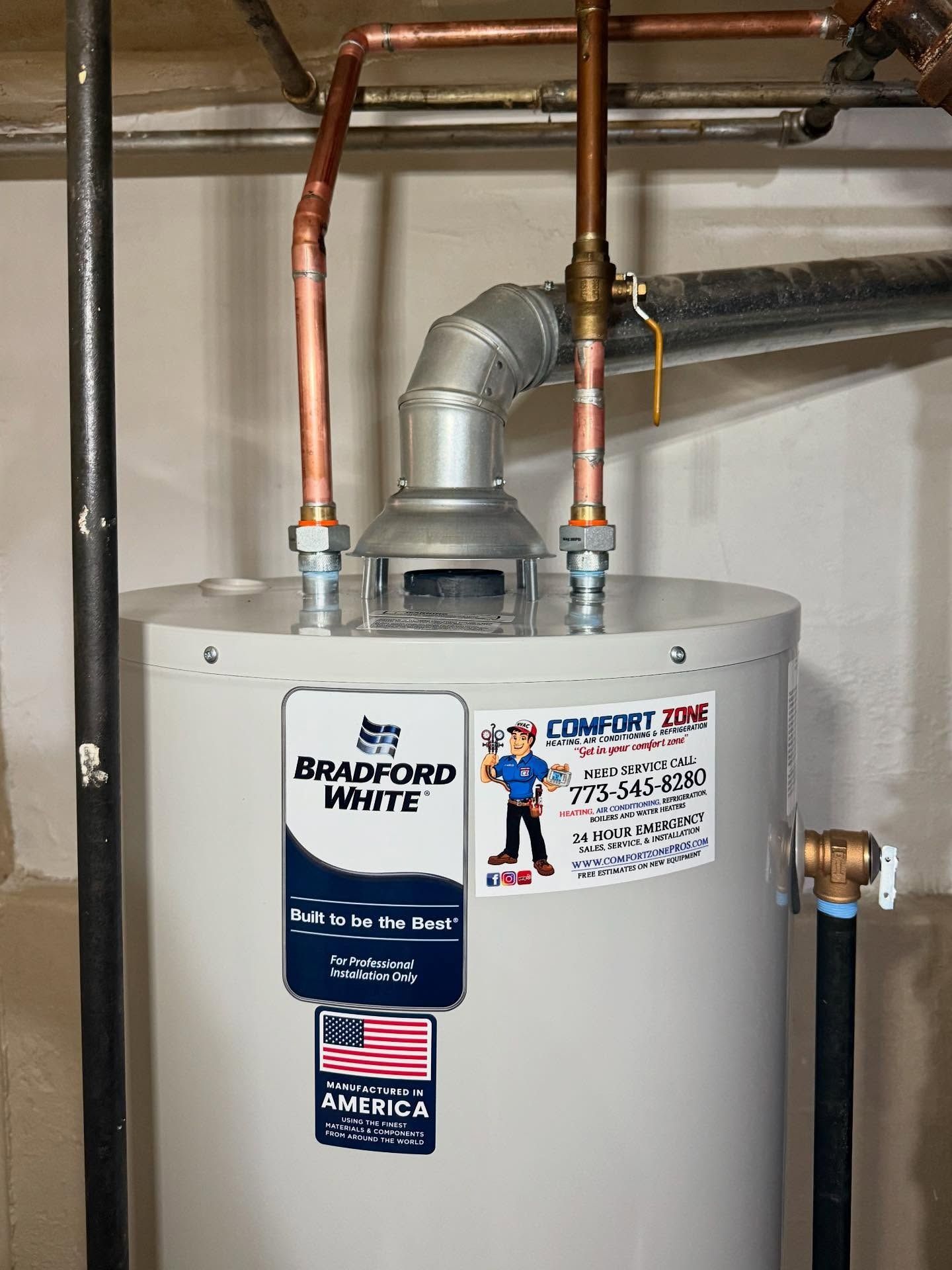 A Bradford White water heater with copper pipes in a basement.