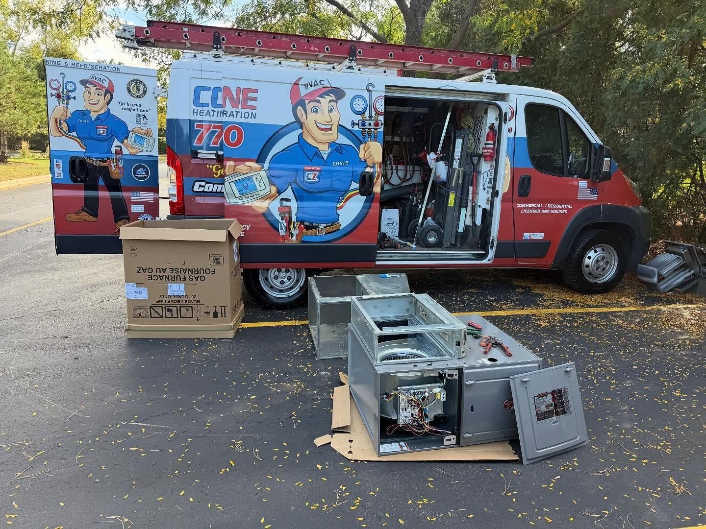 HVAC service van with open doors and tools; furnace components on the ground.