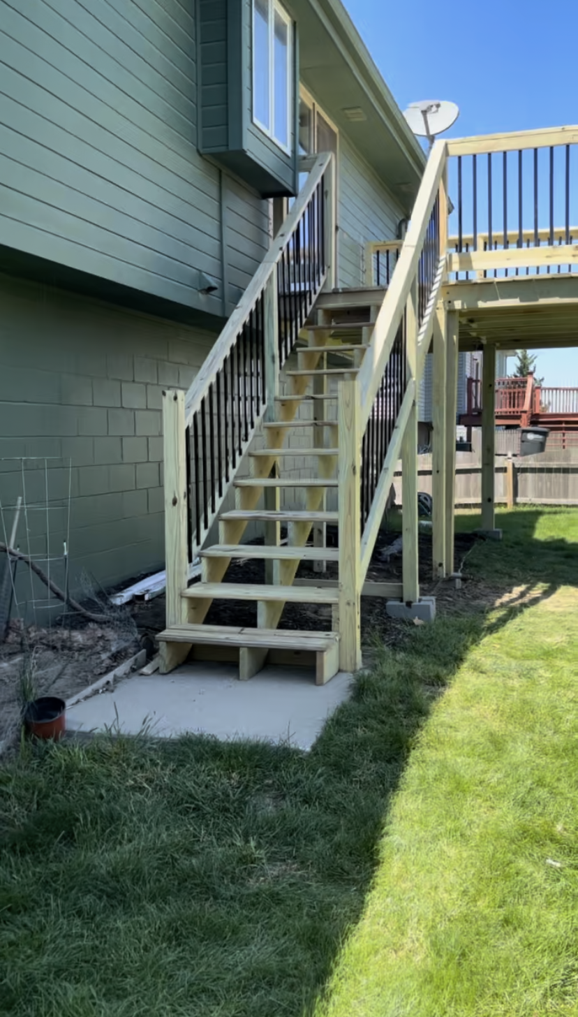 A wooden deck with stairs leading up to it.