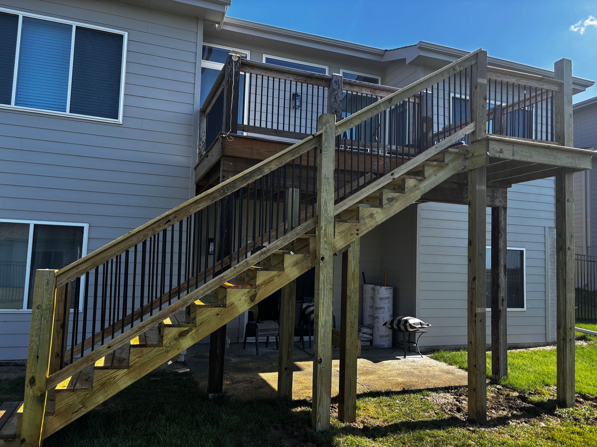 A wooden deck with stairs leading up to it