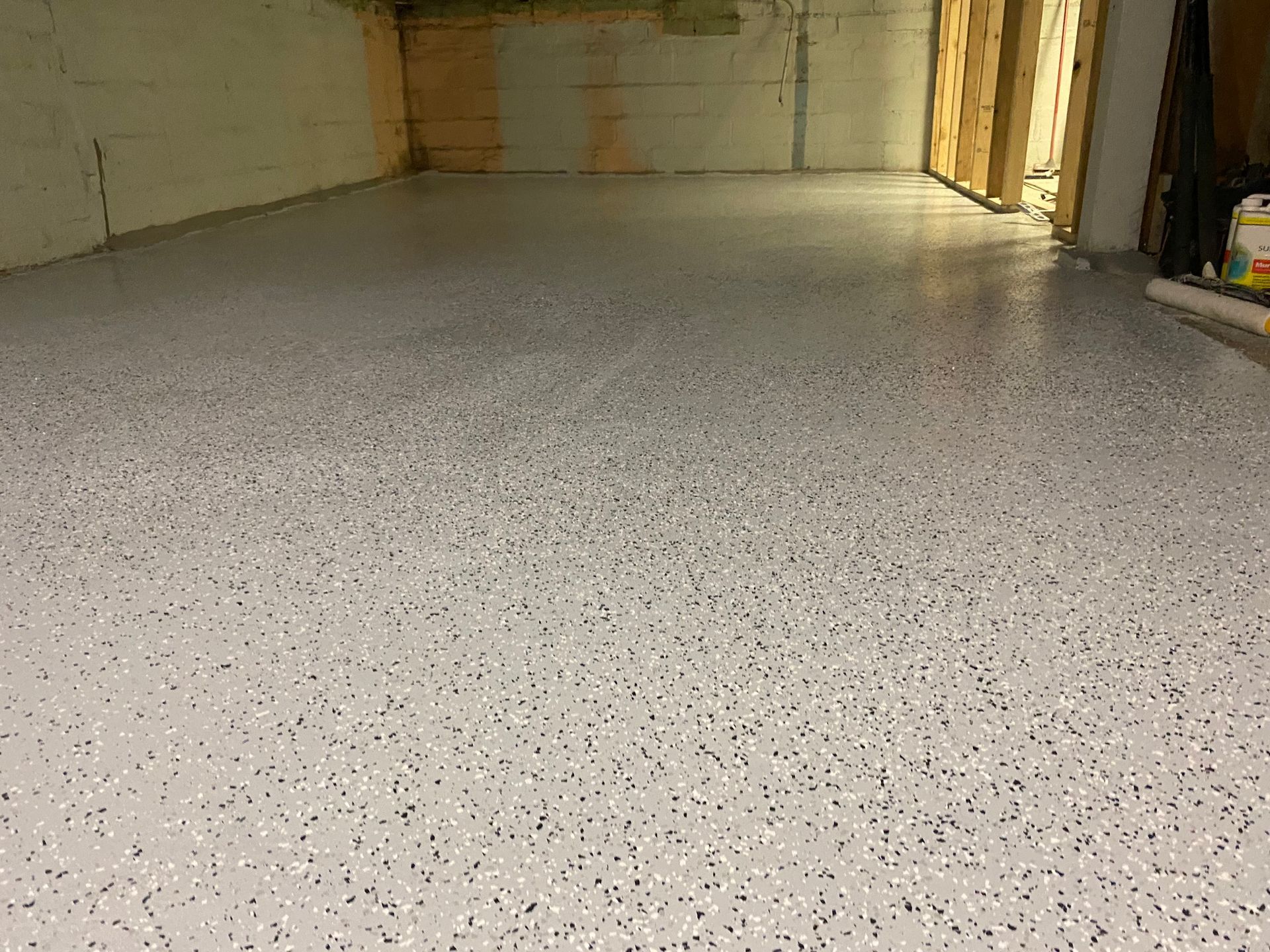 A garage floor with a lot of small dots on it.