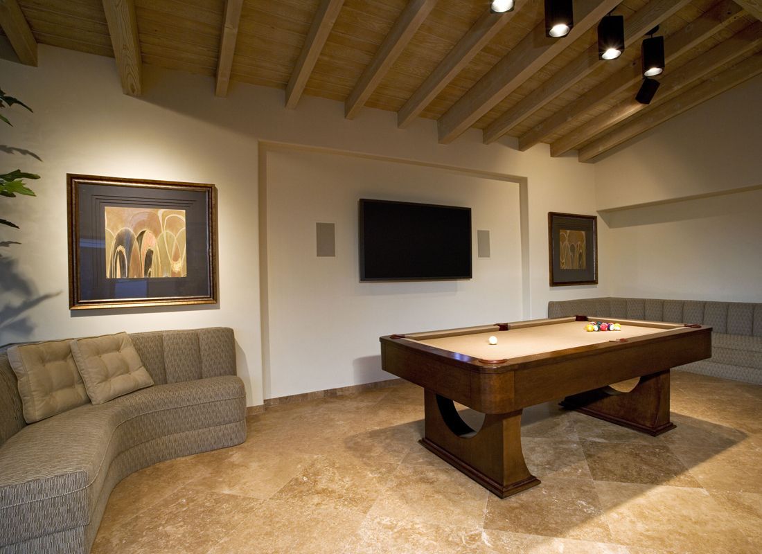 A living room with a pool table and a flat screen tv
