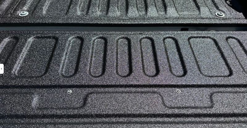 A close up of a truck bed with a spray on bedliner.