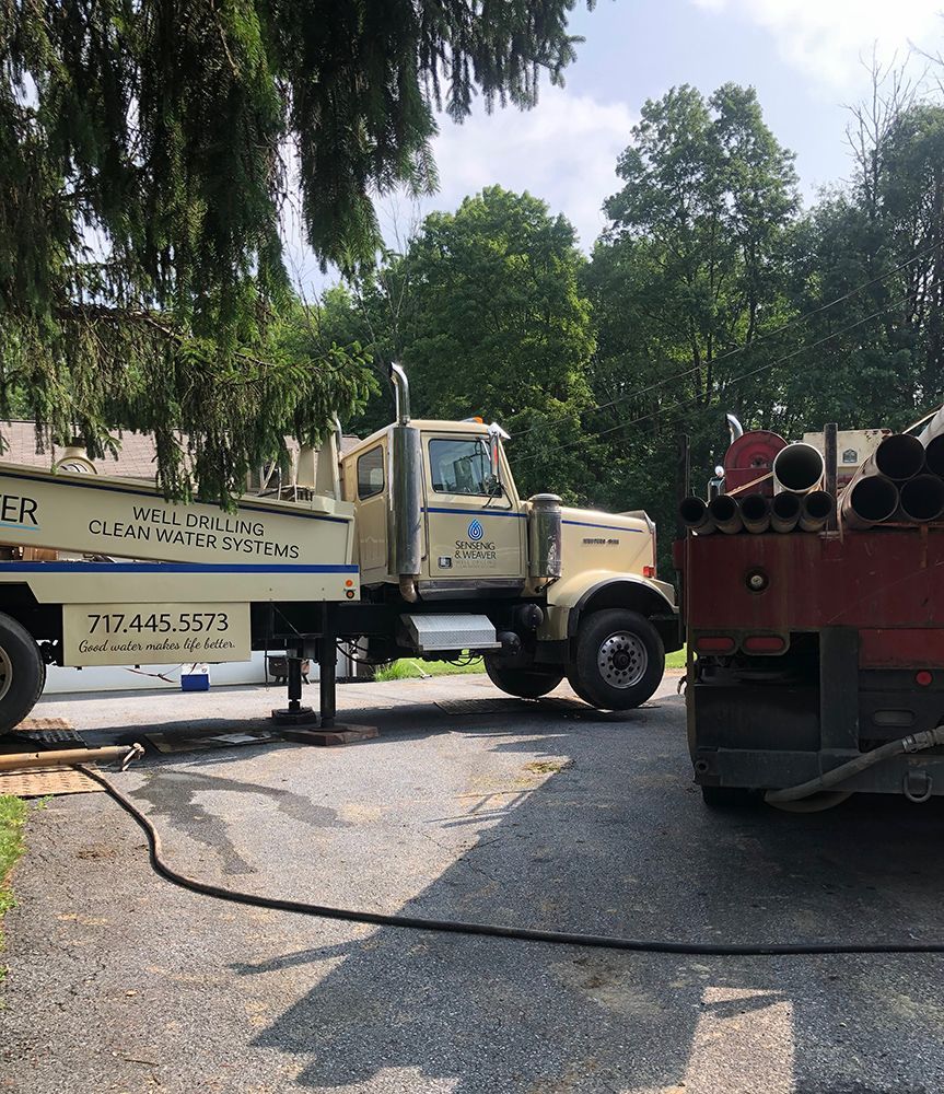 Two trucks are parked on the side of the road.