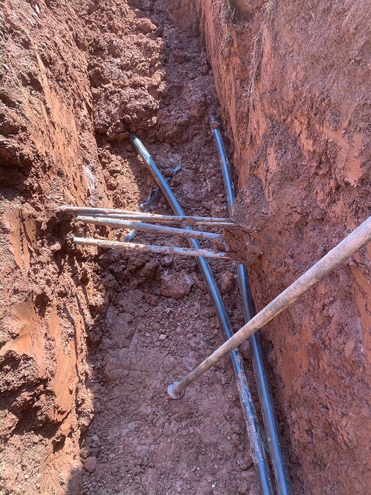 A person is digging a hole in the ground with a shovel.