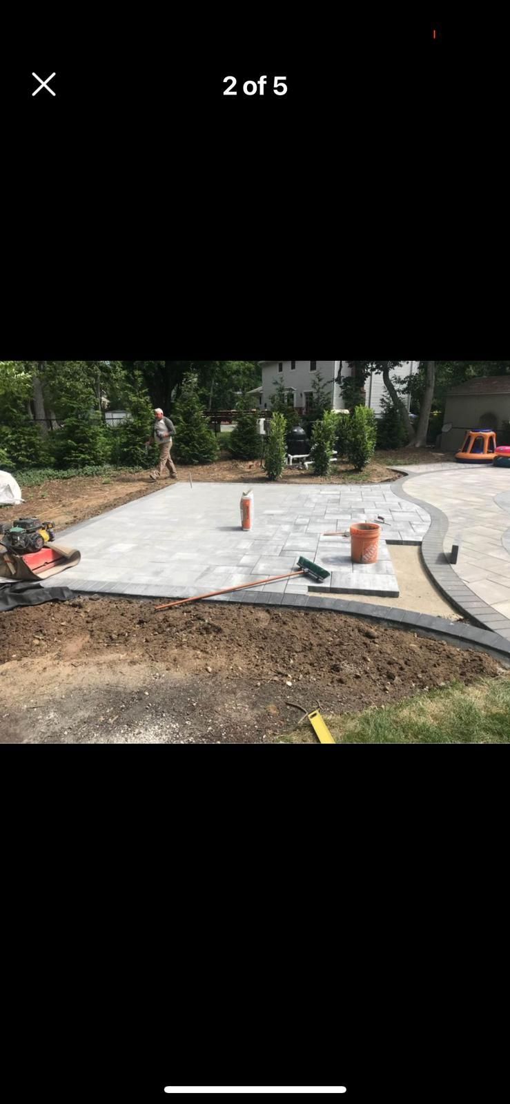 A concrete driveway is being built in a backyard.