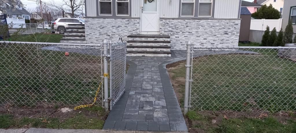There is a walkway leading to the front door of a house.