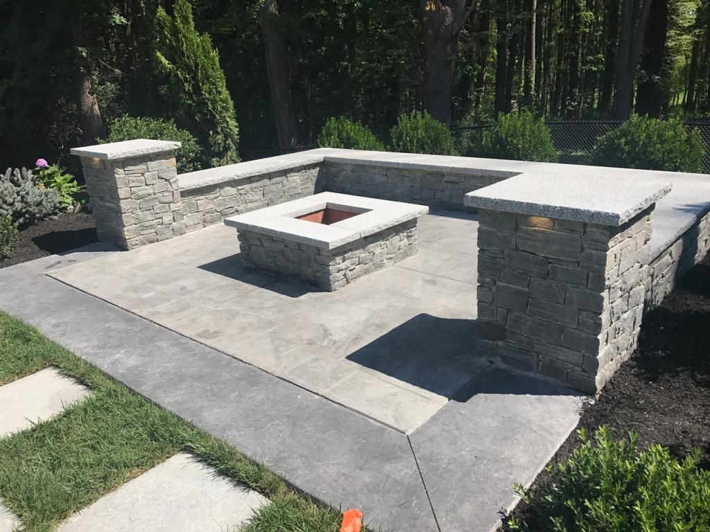 There is a fire pit in the middle of the patio.