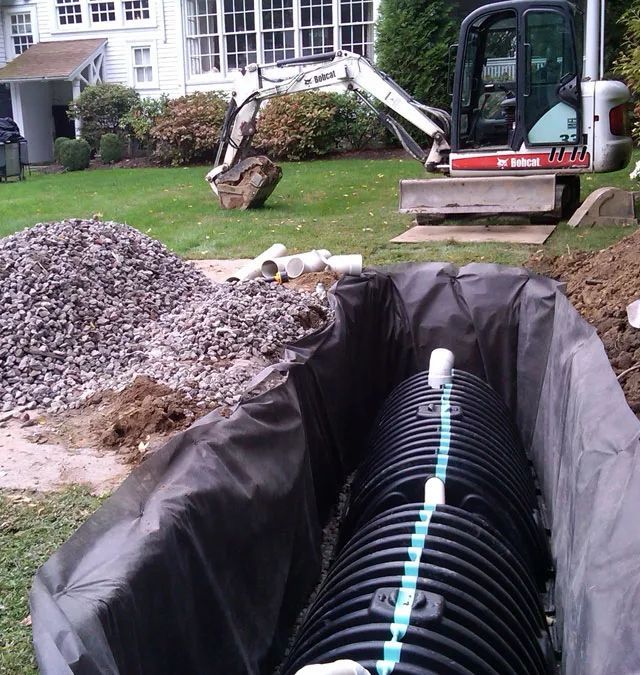 A bobcat excavator is working on a septic system