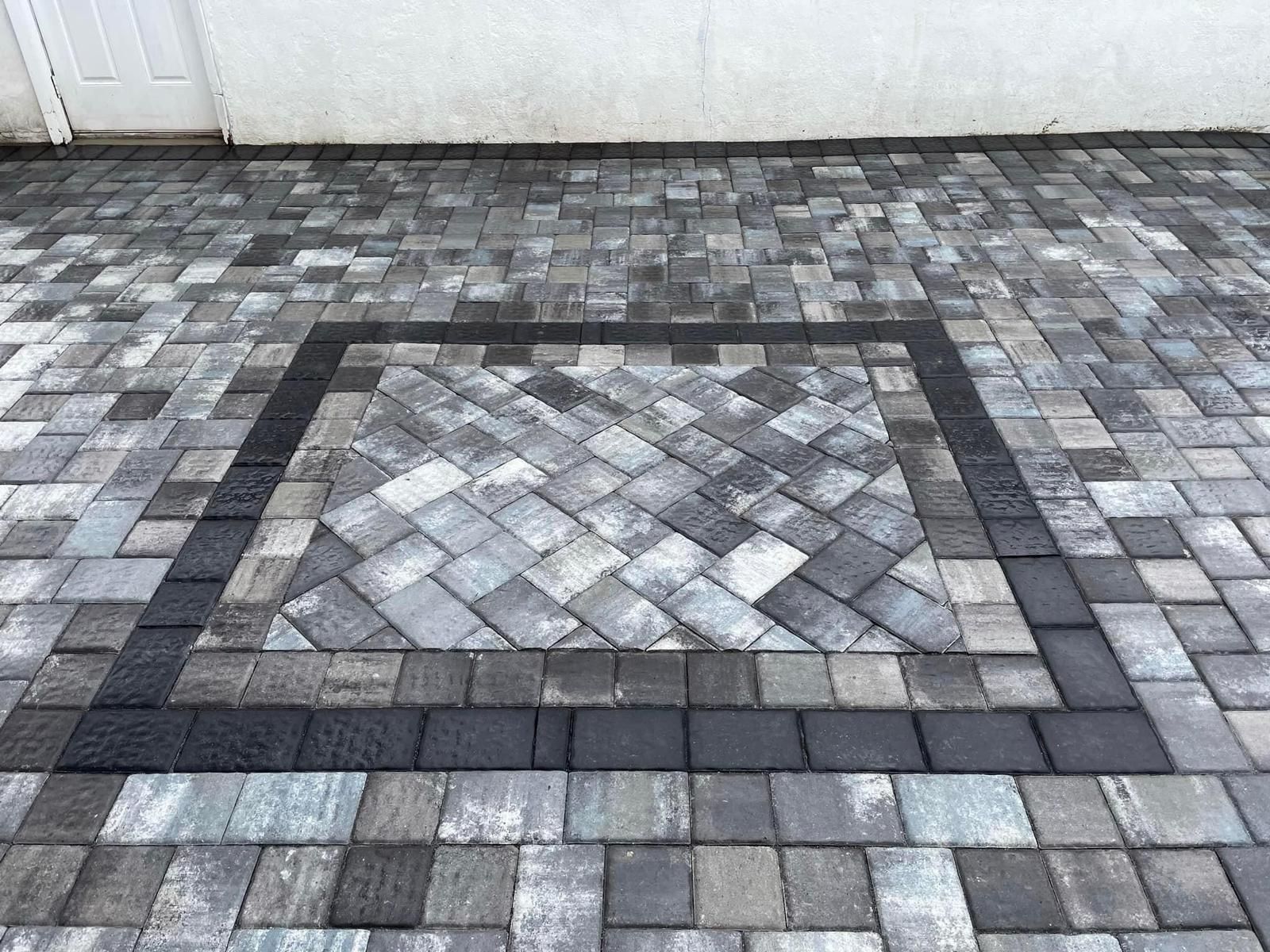 There is a square in the middle of the pavement.