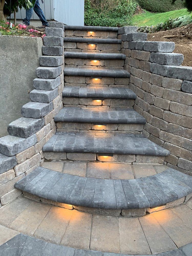 A set of stairs made of bricks with lights on the steps.