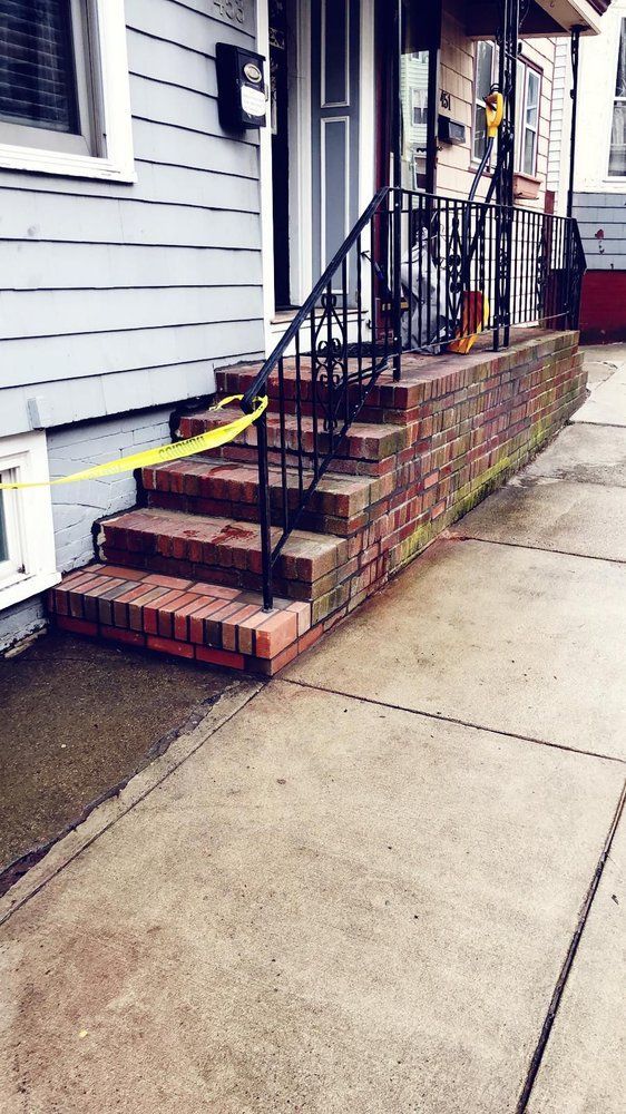 A set of stairs leading up to the front door of a house.