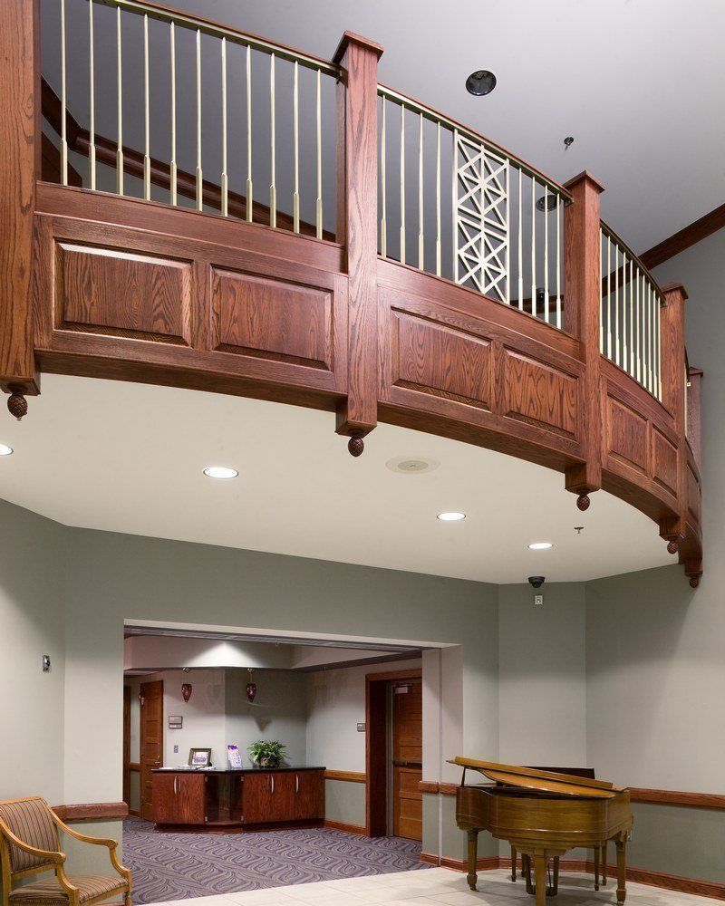 A large room with a piano and a balcony