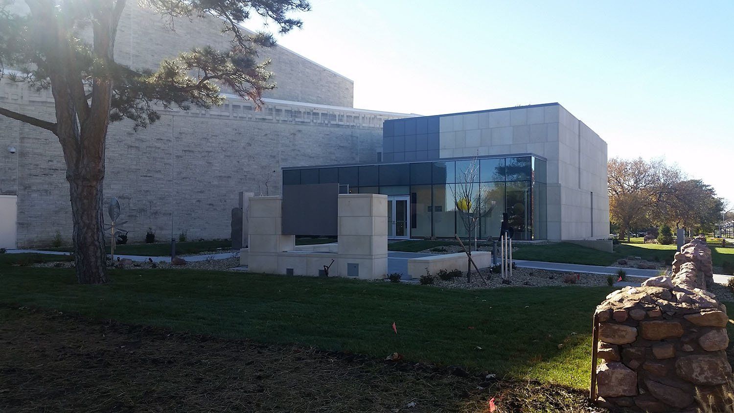 A large building with a lot of windows and a tree in front of it.