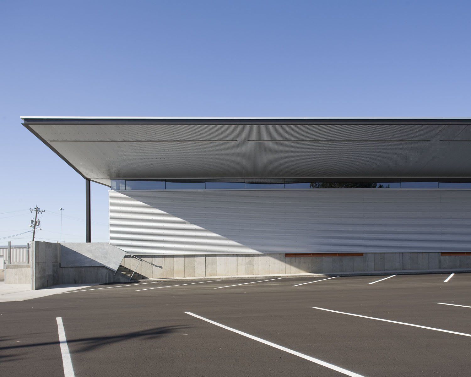 A parking lot with a building in the background