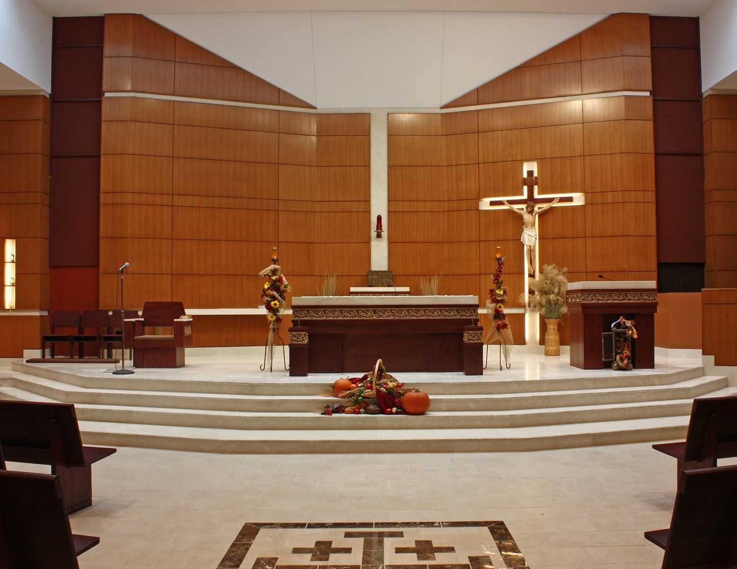 A church with a cross and pumpkins on the altar