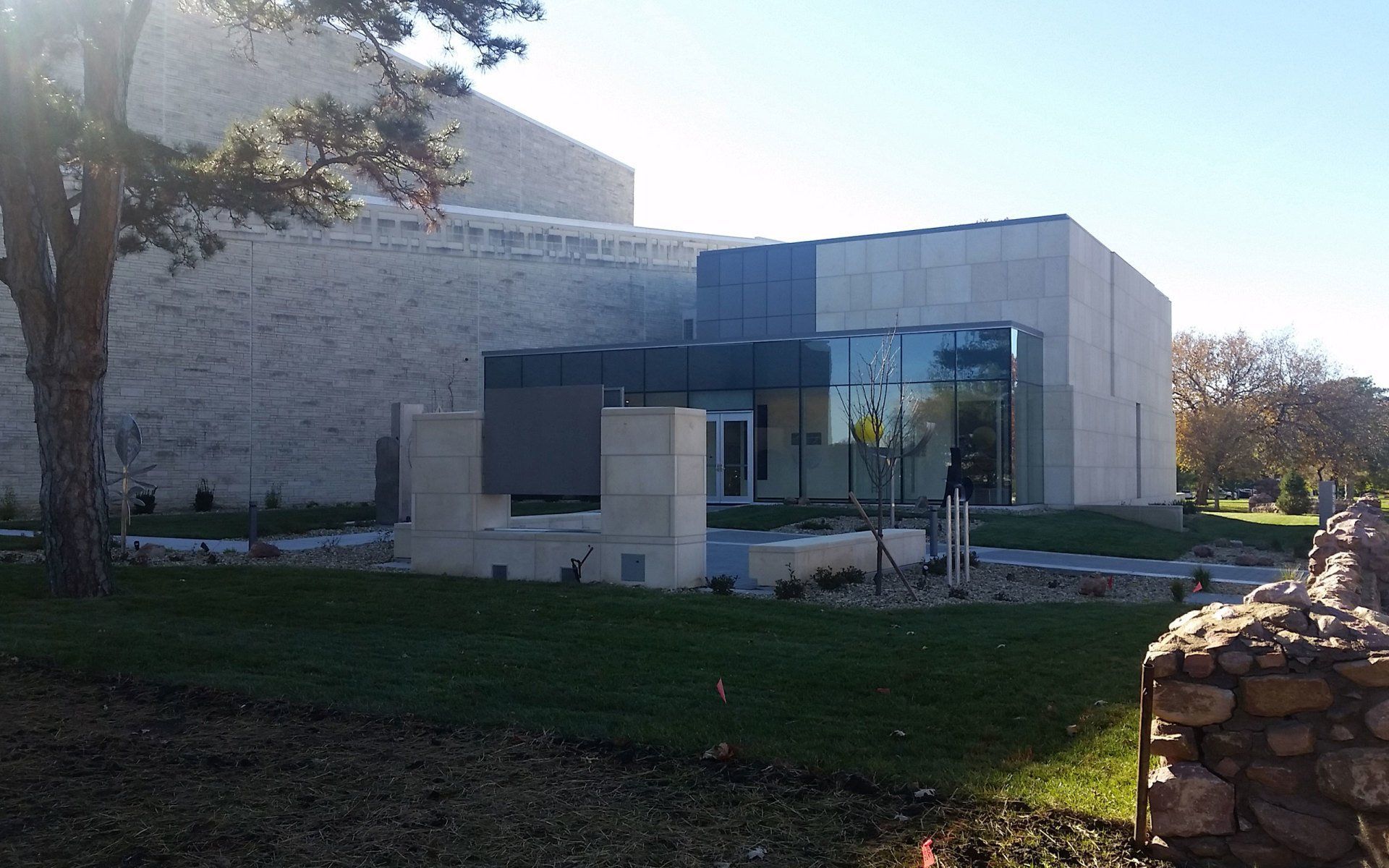 A large building with a lot of windows and a tree in front of it.
